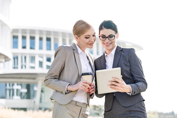 Happy businesswomen using tablet PC — Stock Photo, Image