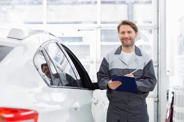 Meccanico automobilistico in piedi in auto — Foto Stock