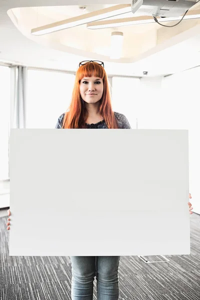 Businesswoman holding blank placard — Stock Photo, Image