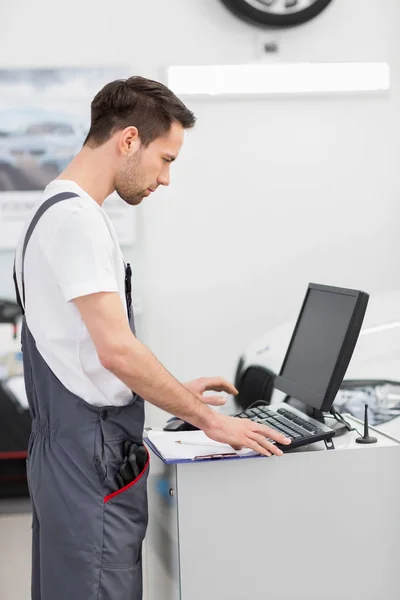 Mecânico de automóveis usando computador — Fotografia de Stock