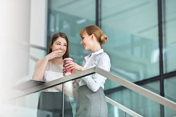 Businesswomen gossiping while having coffee — Stock Photo, Image