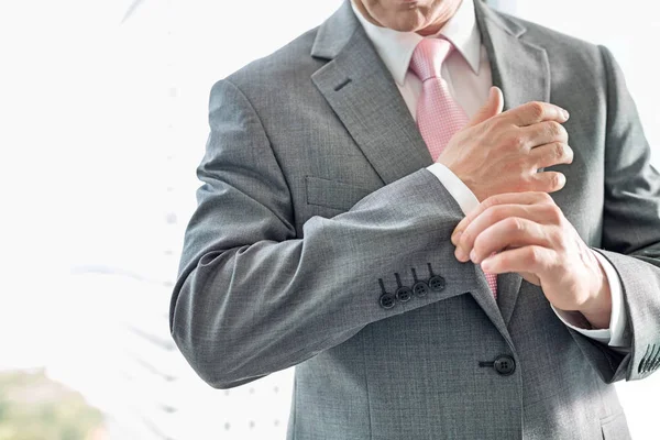 Businessman buttoning sleeve — Stock Photo, Image