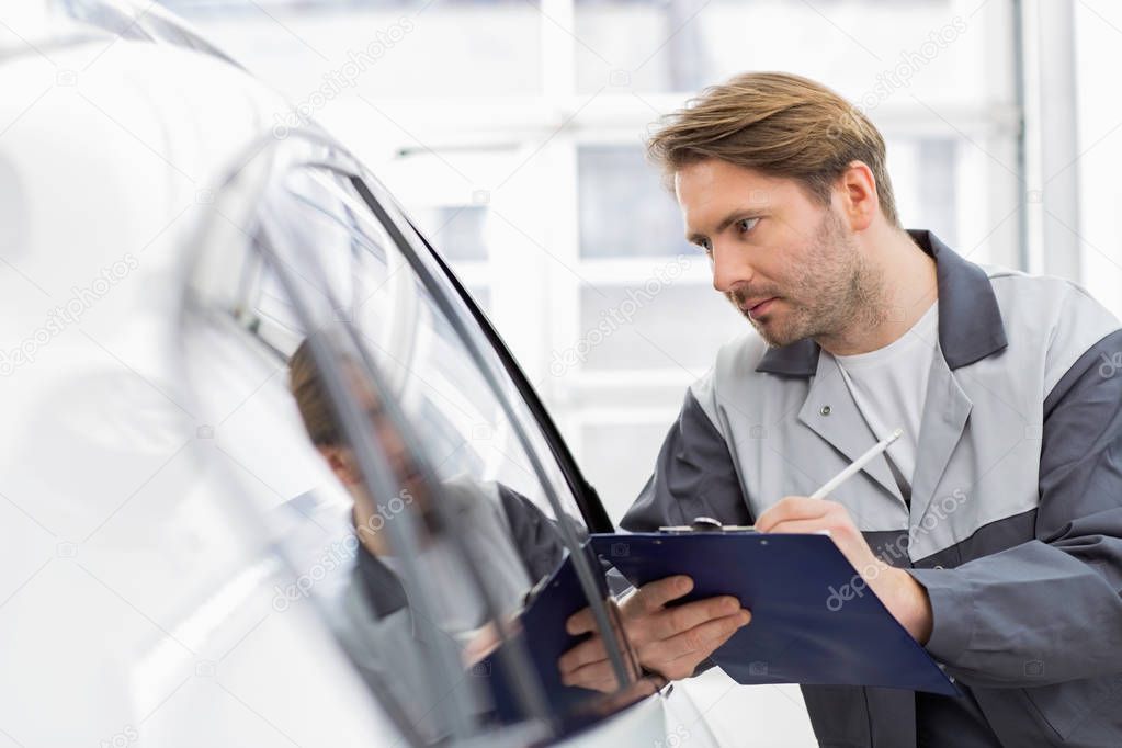 repair worker while examining car