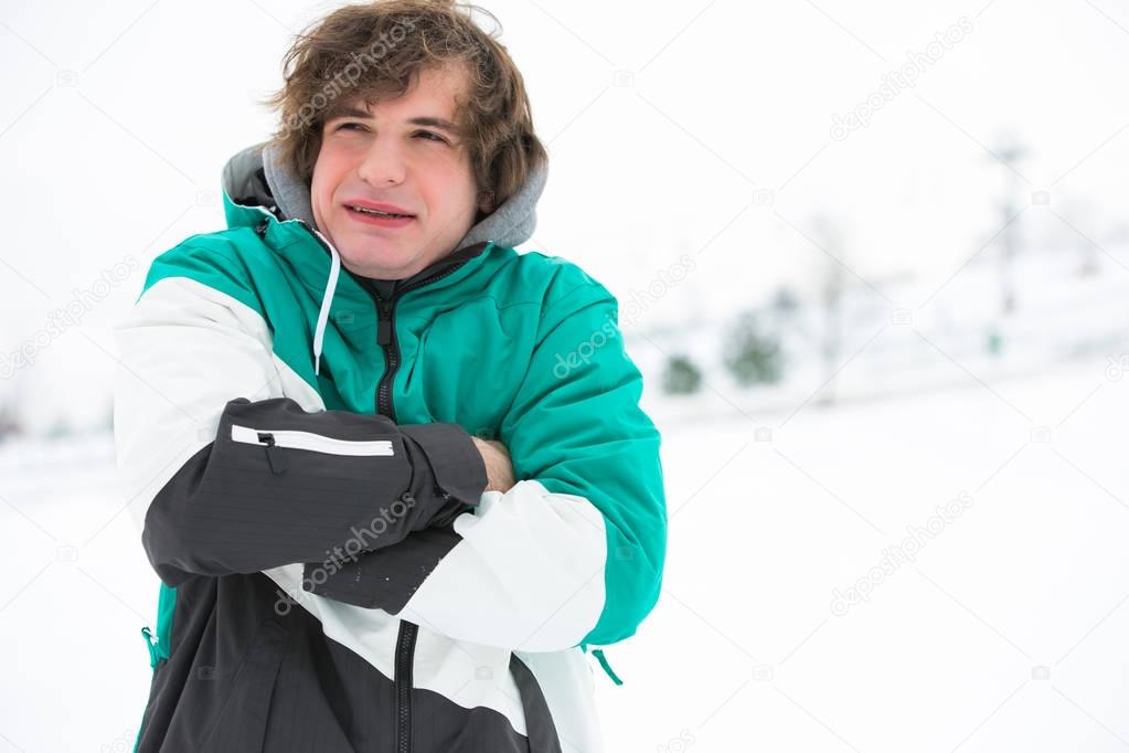 Young man in jacket shivering 