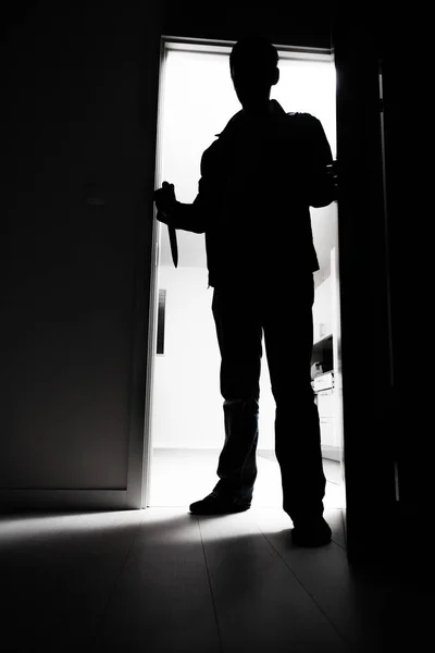 Thief with knife entering into room — Stock Photo, Image