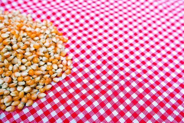 Corn kernels on tablecloth — Stock Photo, Image