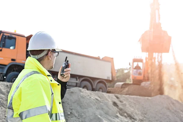 Supervisor using walkie-talkie at construction site — Stock Photo, Image