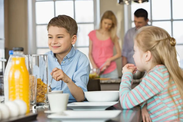 Syskon med frukost vid bord — Stockfoto