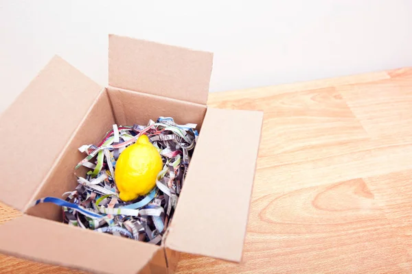 Lemon wrapped in box — Stock Photo, Image