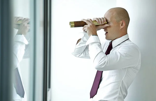 Businessman spying using telescope — Stock Photo, Image