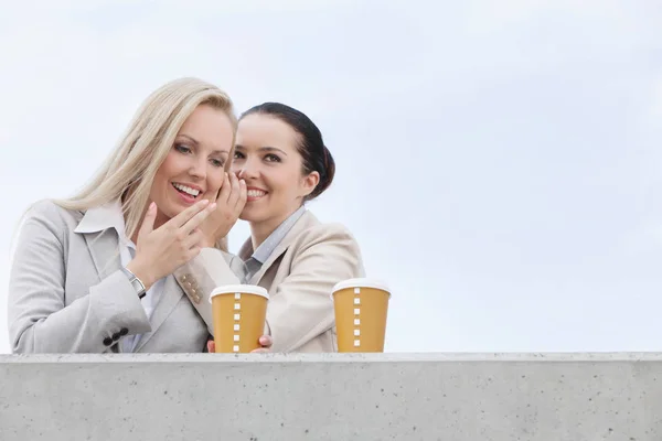 Businesswomen with disposable coffee cups — Stock Photo, Image