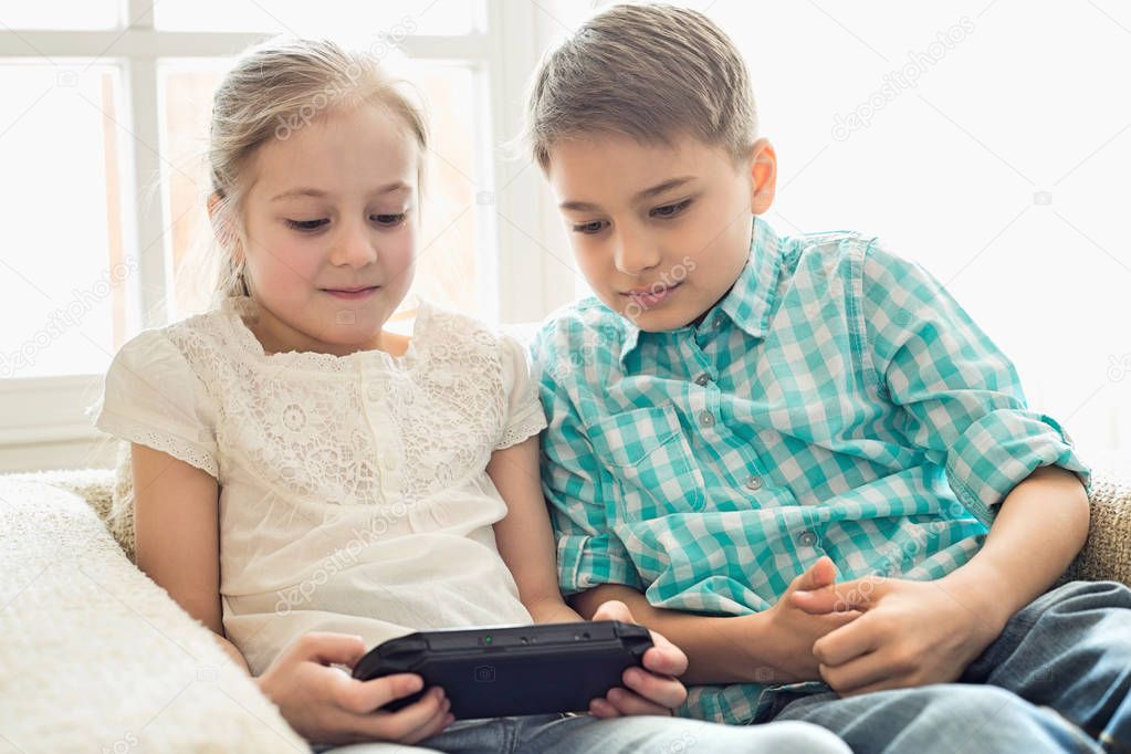 Siblings playing video game