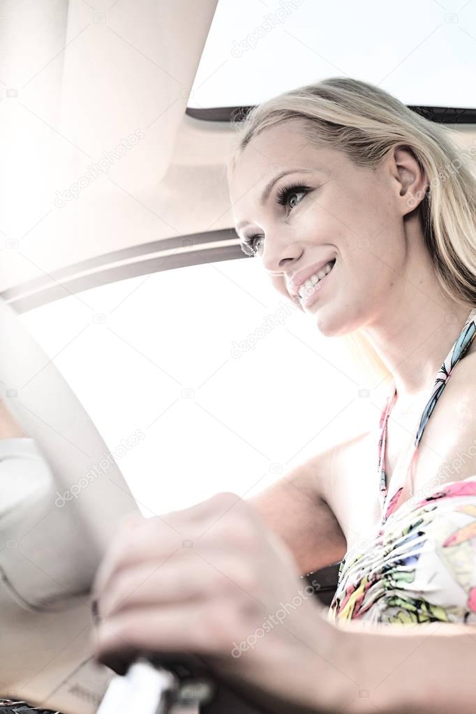 smiling woman driving car