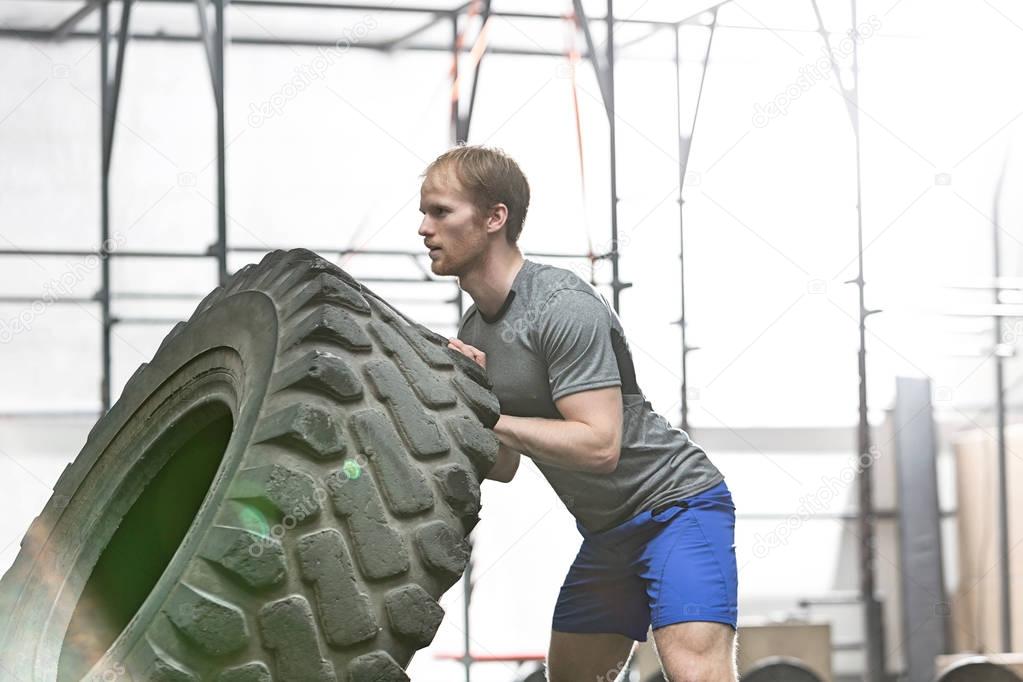 dedicated man flipping tire