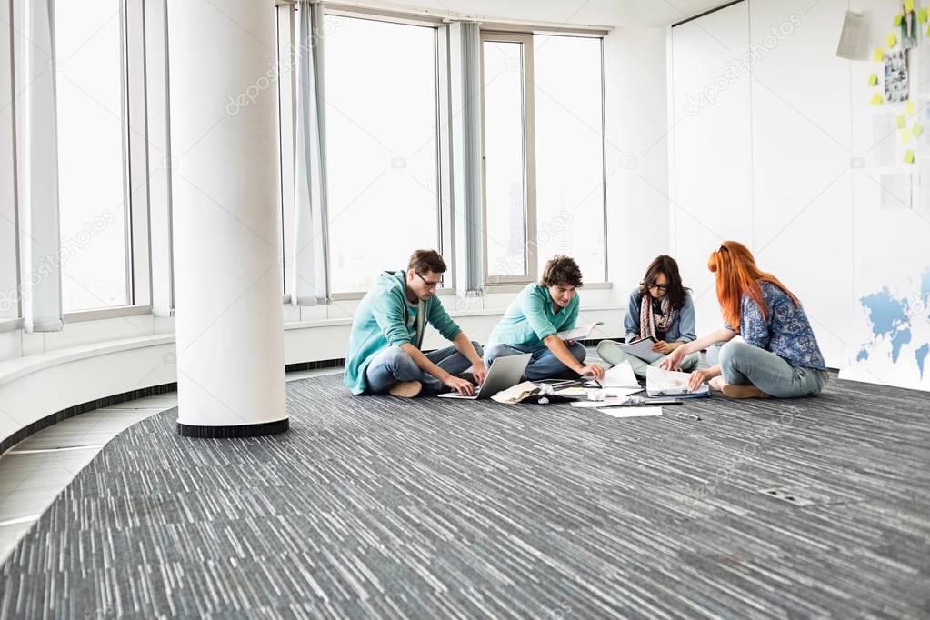 Creative businesspeople working on floor