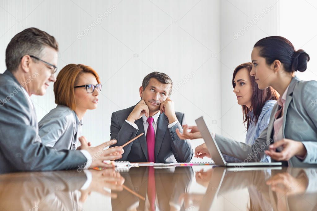 Businesspeople arguing in meeting