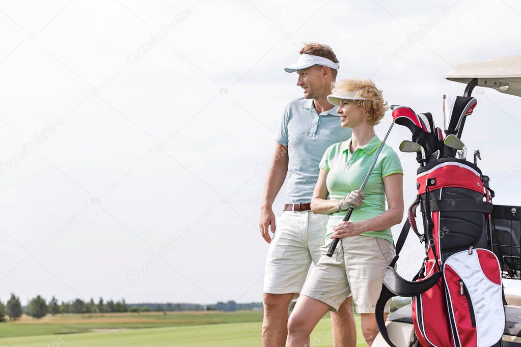 Smiling man and woman at golf course