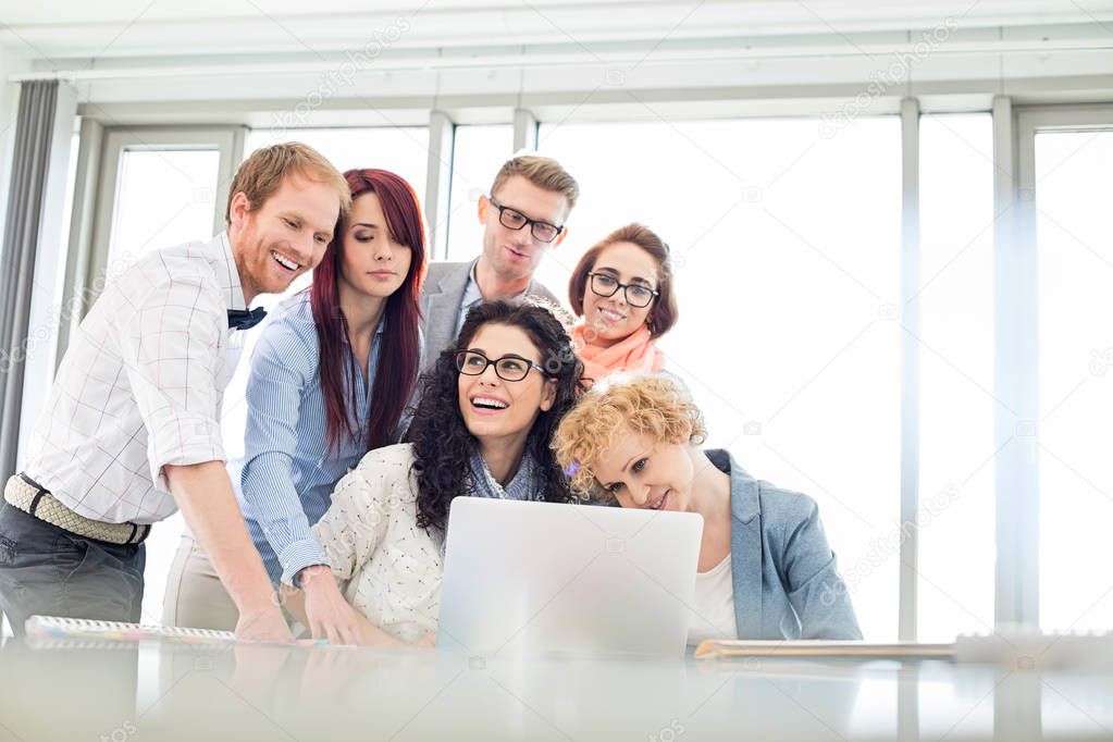 Happy business colleagues with laptop 