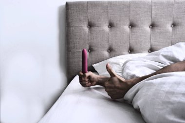 Woman holding a Vibrator Dildo