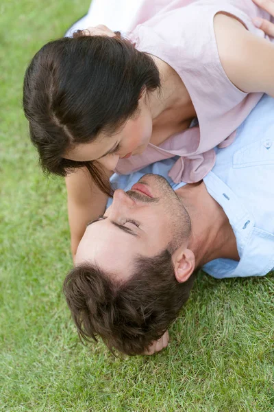 Couple lying together in park — Stock Photo, Image