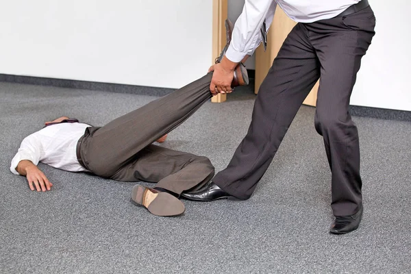 Businessmen pulling colleague — Stock Photo, Image