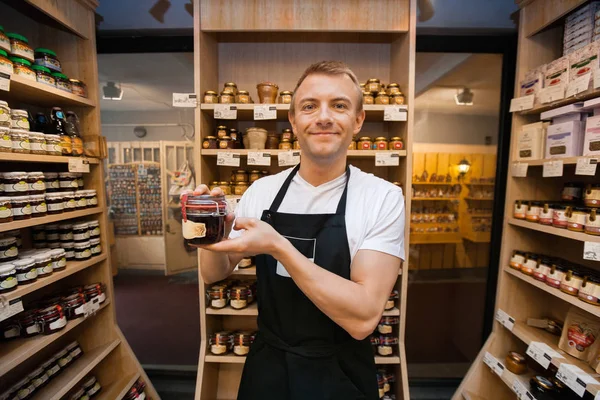 Salesman holding jar of jam — Stock Photo, Image