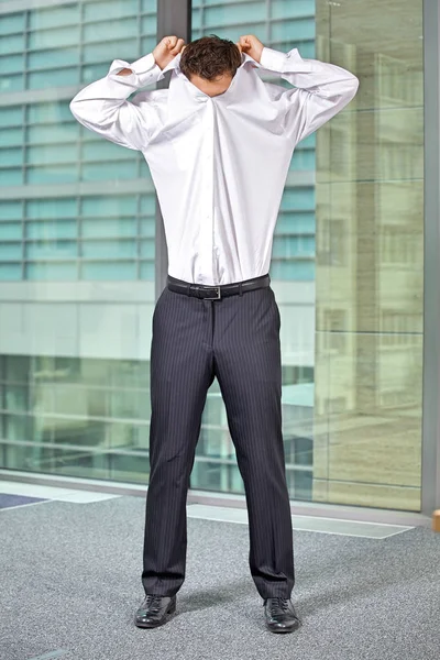 Businessman removing shirt — Stock Photo, Image