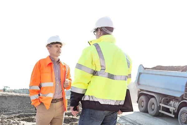 Engineers discussing at construction site — Stock Photo, Image