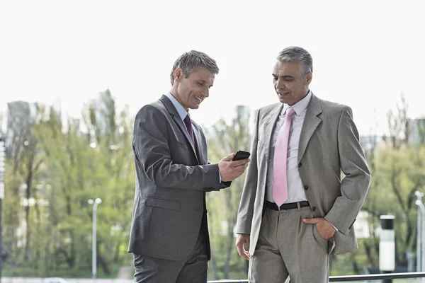 Businessmen using cell phone — Stock Photo, Image