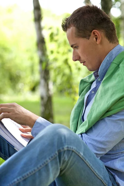 Man reading book in park — Stock Photo, Image