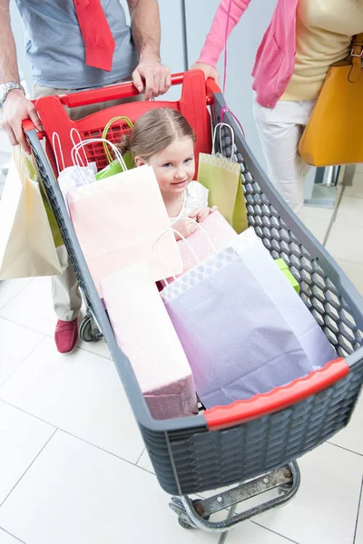 Girl in shopping trolley — Stock Photo, Image