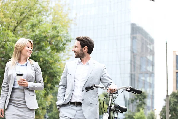 Businesspeople with bicycle and disposable cup — Stock Photo, Image
