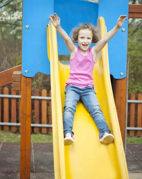 Young girl on slide — Stock Photo, Image