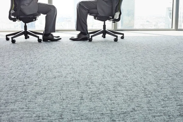 Businessmen sitting on office chairs — Stock Photo, Image