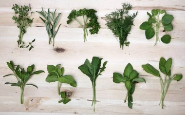 Herbs on wooden background clipart