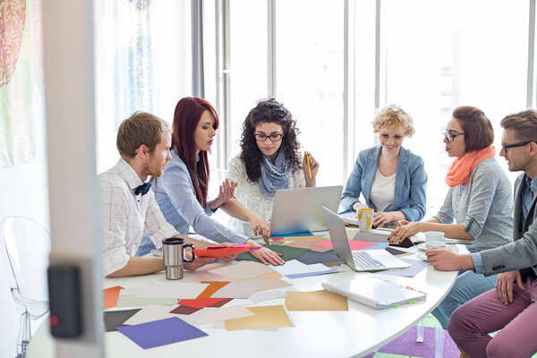 Creative businesspeople analyzing photographs