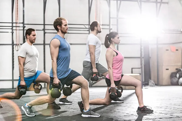 Determined people lifting kettlebells — Stock Photo, Image