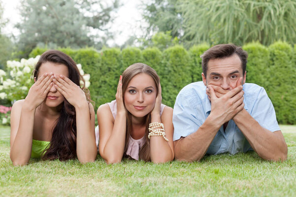 friends covering mouth, ears and eyes 