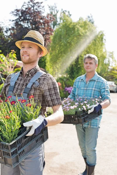 Gardeners carrying flower pots — Stock Photo, Image