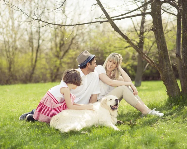 Familia sentada con perro — Foto de Stock