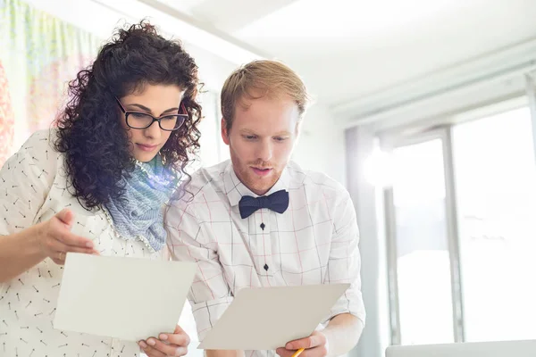 Businesspeople discussing over samples — Stock Photo, Image