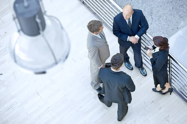 Businessmen and businesswoman standing together — Stock Photo, Image