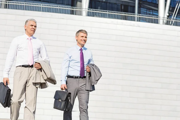 Middle-aged businessmen with briefcases — Stock Photo, Image