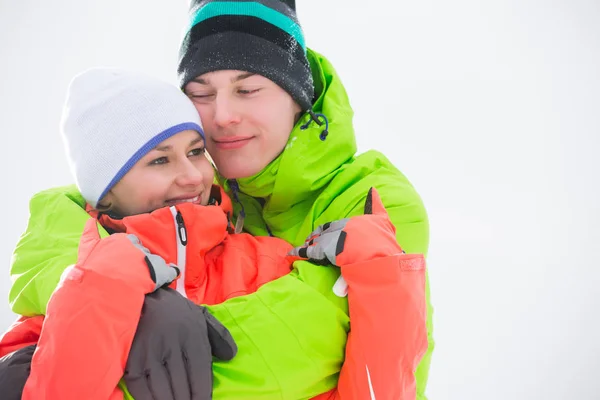 Couple in warm clothing embracing — Stock Photo, Image