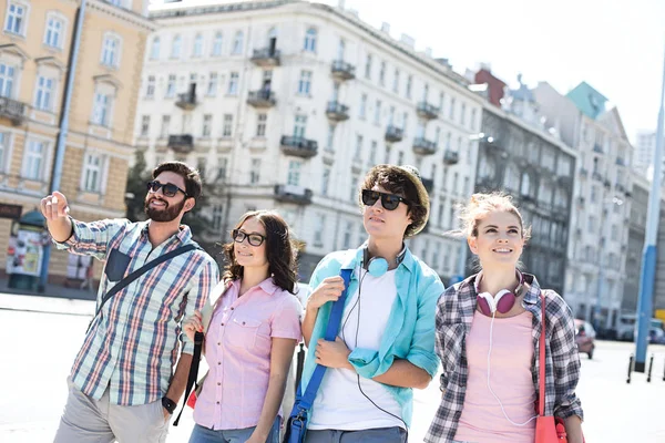 Happy male and female friends walking — Stock Photo, Image