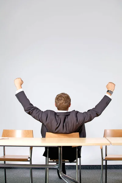 Businessman sitting in office with outstretched — Stock Photo, Image