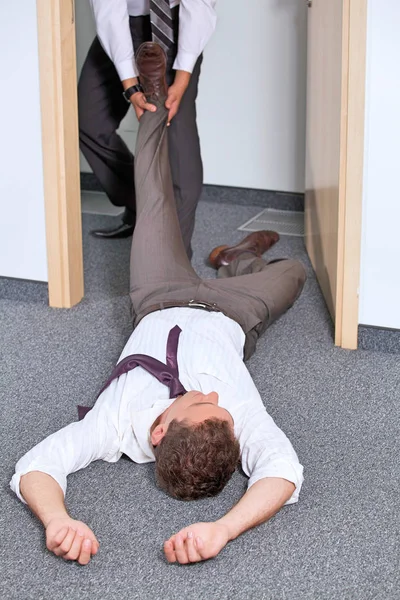 Businessmen pulling colleague — Stock Photo, Image