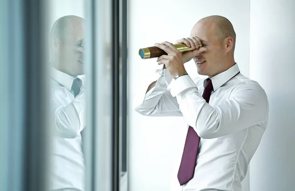 Businessman spying using telescope — Stock Photo, Image
