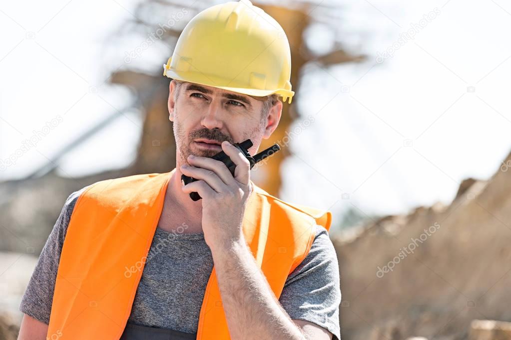 Confident supervisor using walkie-talkie