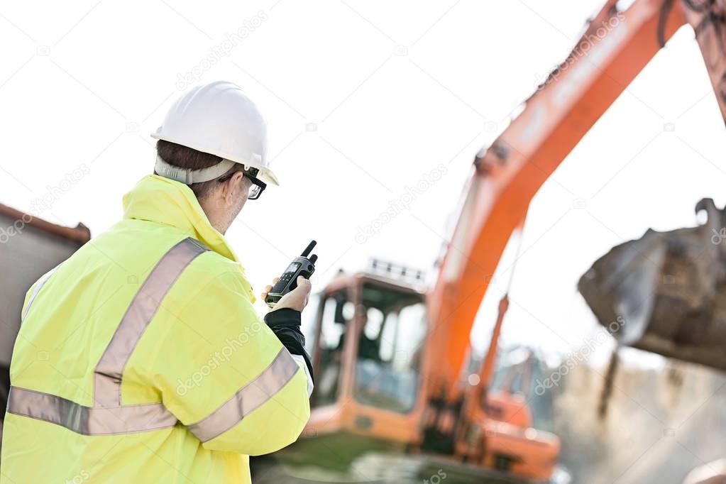 Supervisor using walkie-talkie at construction site